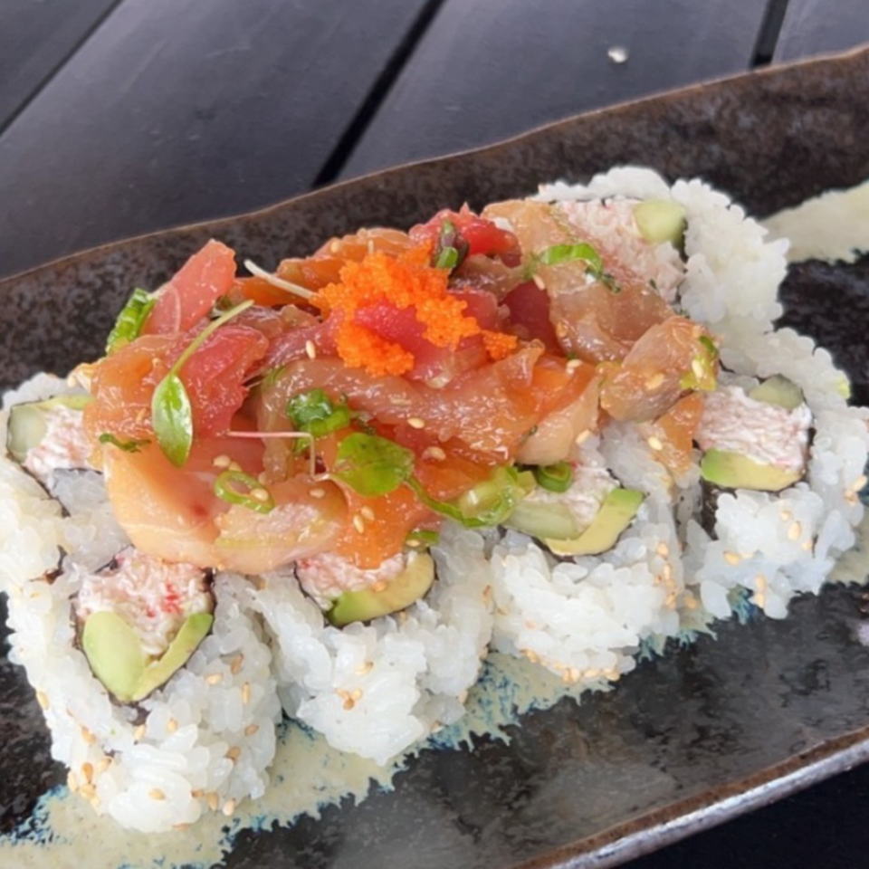 Hanamaru Sushi's California roll topped with fresh tuna, salmon, and orange tobiko.